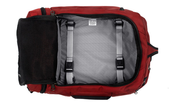 An open Techonaut 30 with a Mars Red (brick red) exterior and a Northwest Sky (grey) interior.